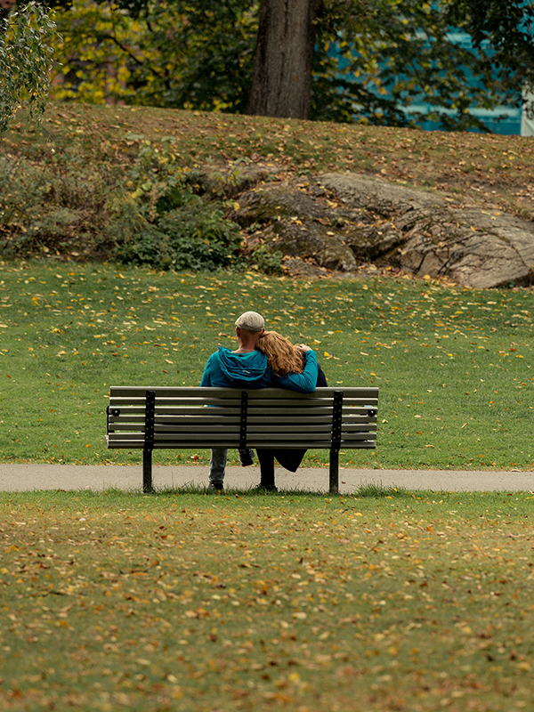 a retired couple sitting on a park bench