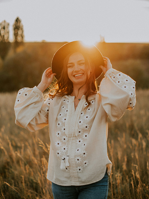 young woman smiling in a field