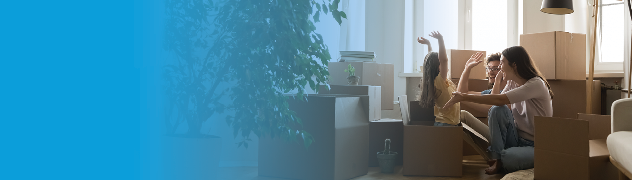 a young family in front of a countryside cottage