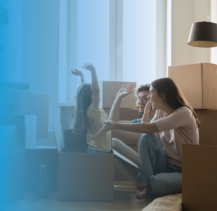 a young family in front of a countryside cottage