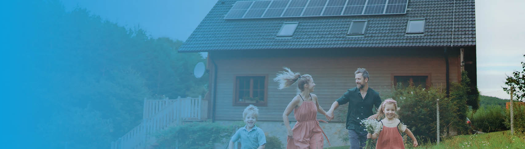 a young family in front of a countryside cottage