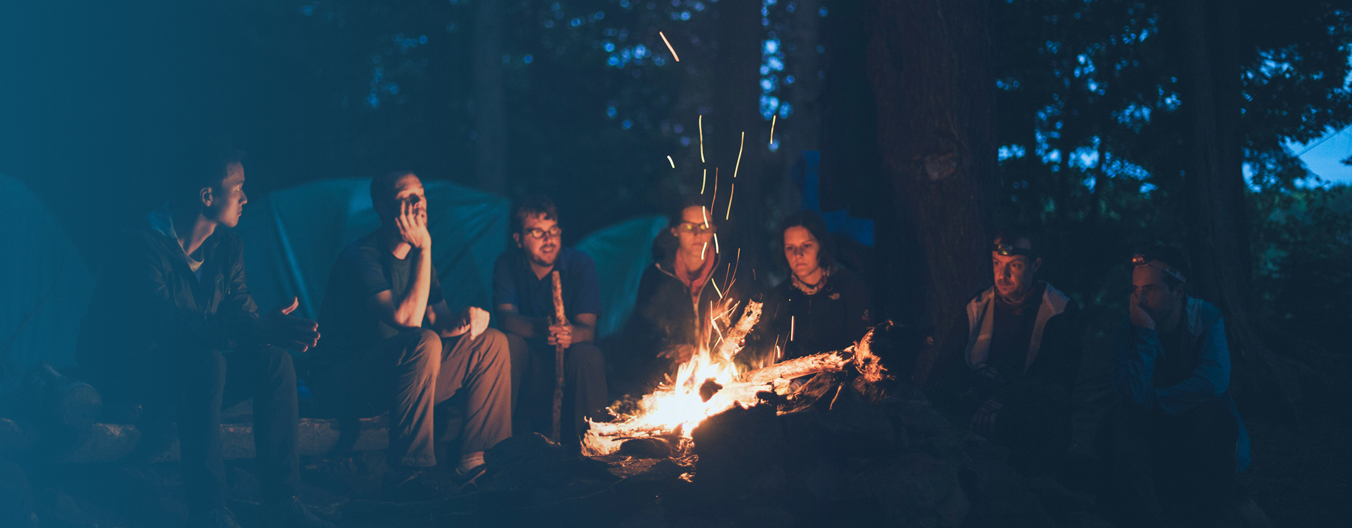 friends enjoying a campfire in a BC forest