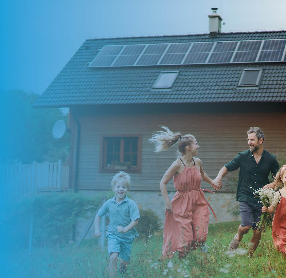 a young family in front of a countryside cottage