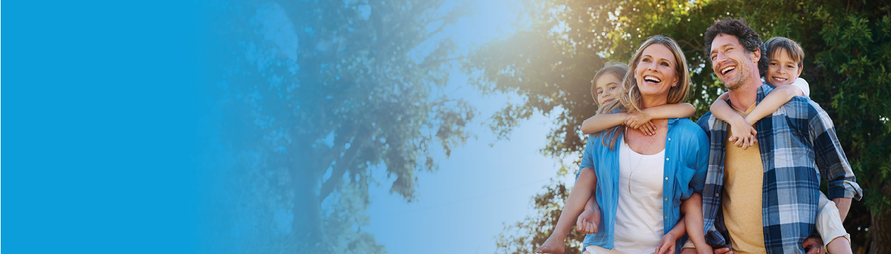 a young family in front of a countryside cottage