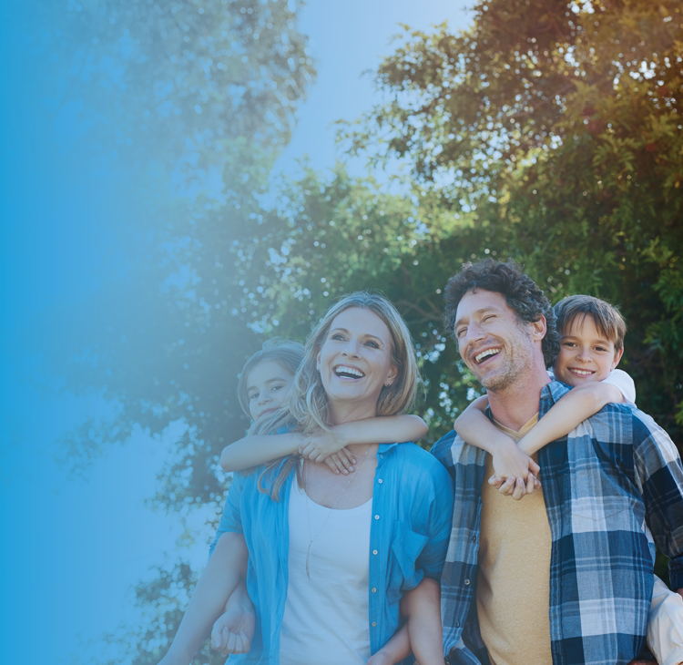 a young family in front of a countryside cottage