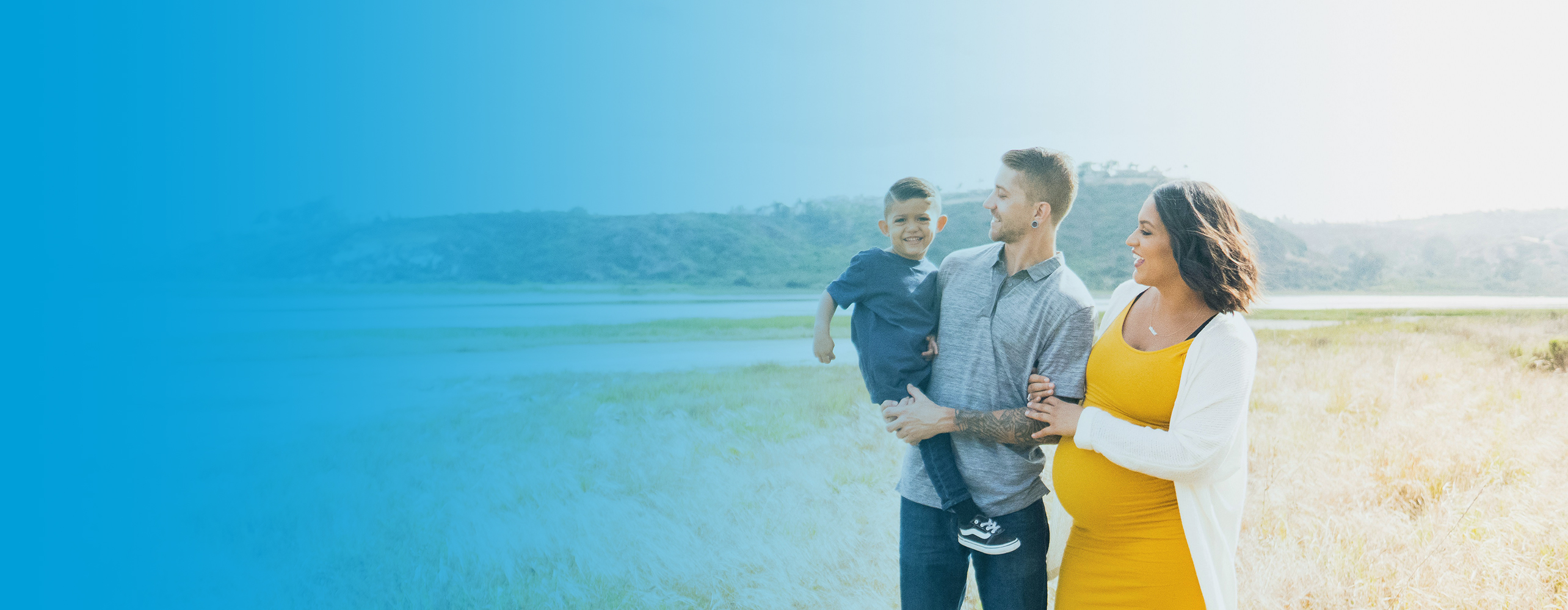 young family in a sunny field